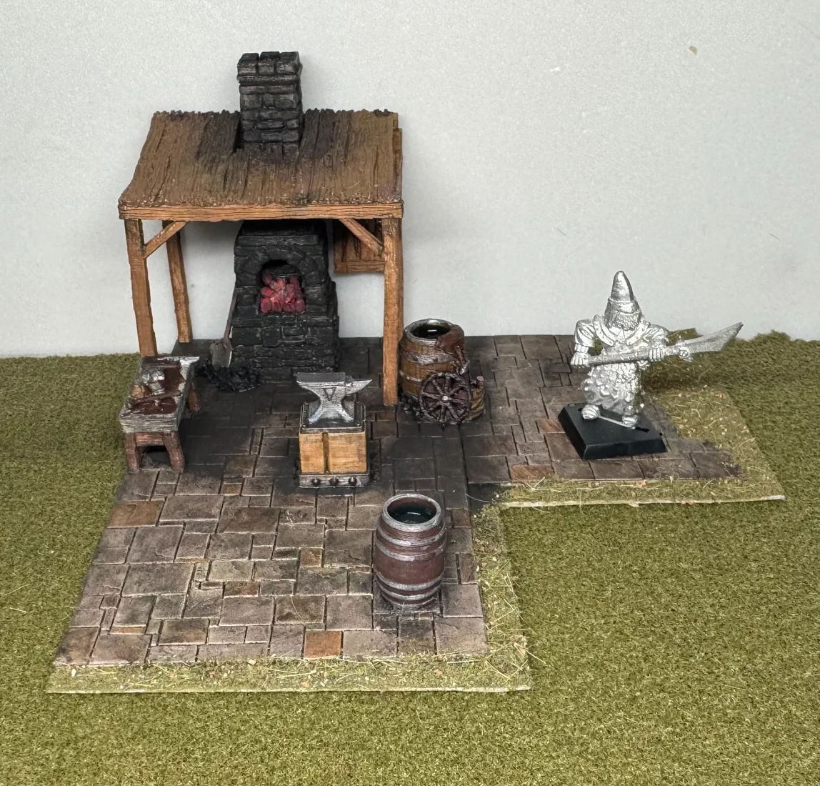 Miniature blacksmith forge and cobbled courtyard with accessories